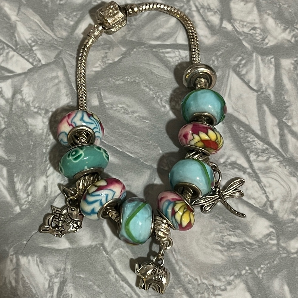 Pandora silver bracelet with bead and silver charms